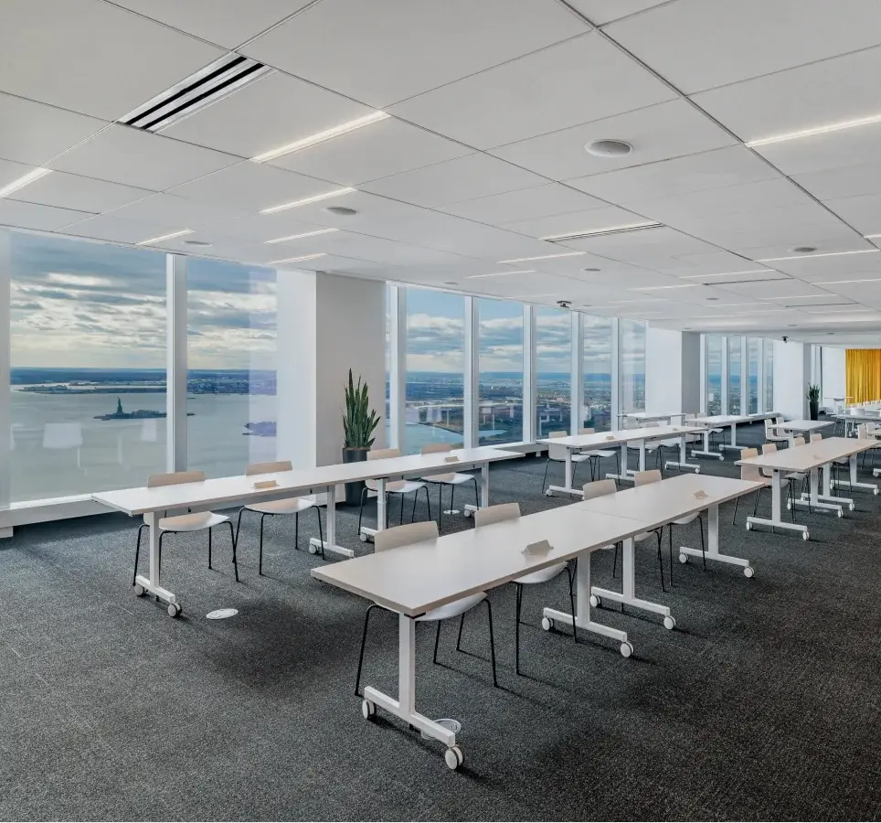 A meeting space with floor to ceiling windows and city views at Well& Durst on the 64th floor of One World Trade Center