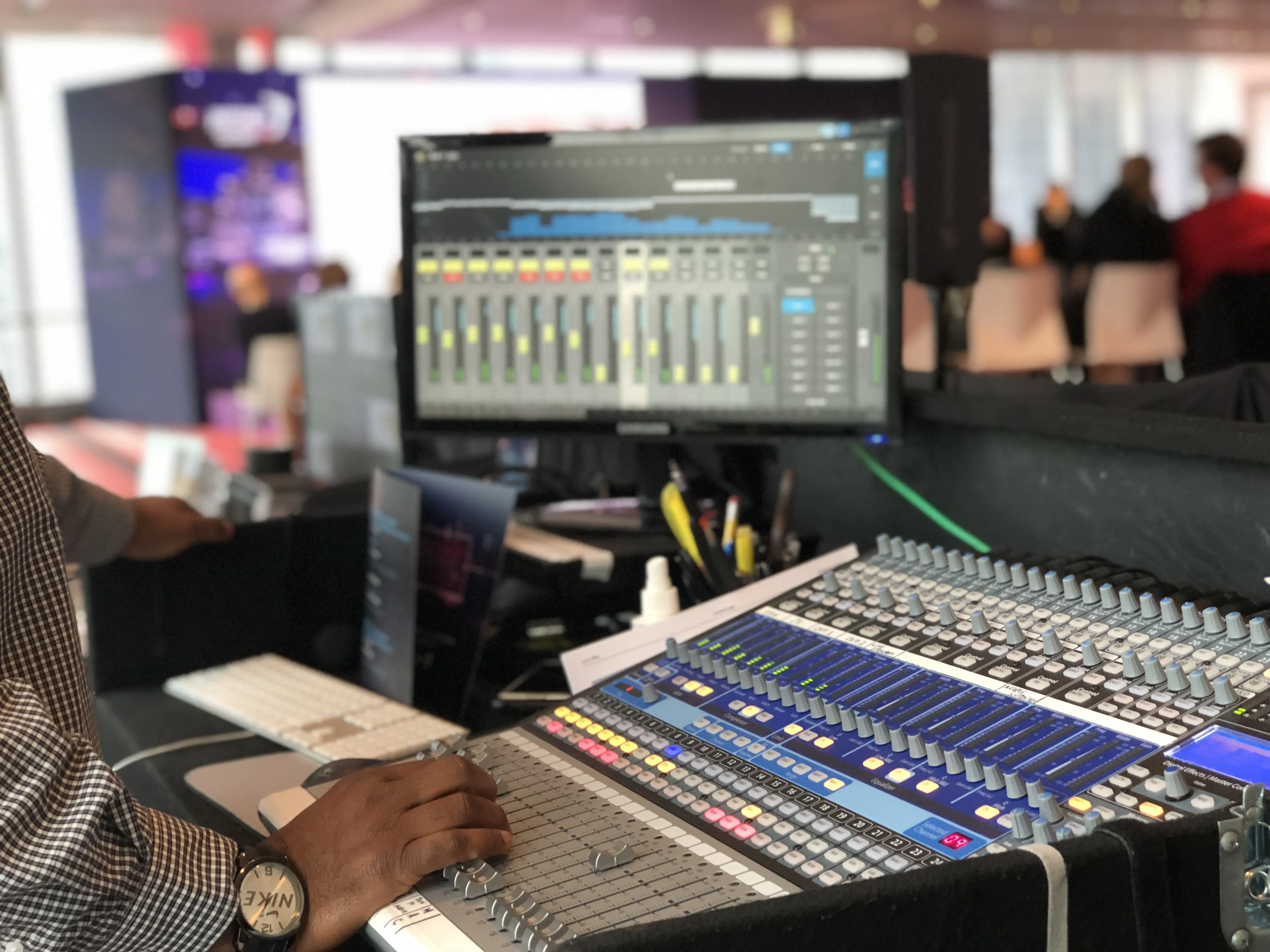 A lighting designer and his control panel at the front of house table during a OWEP event