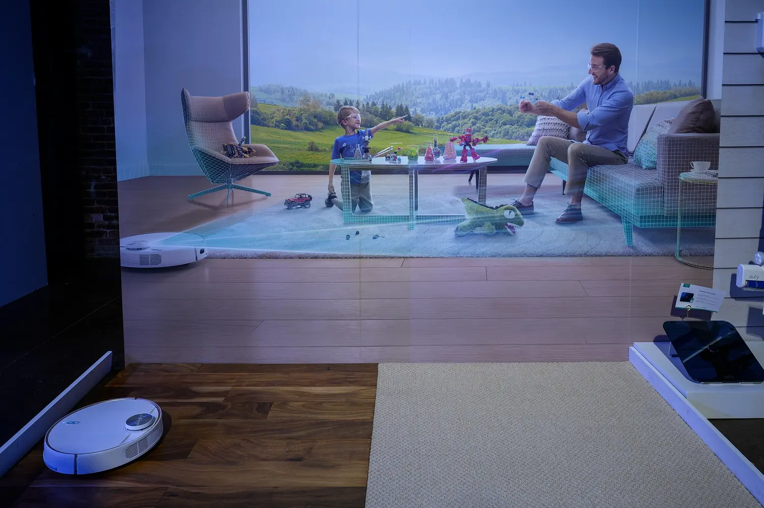 A video display at an event showing a son and father playing in a living room