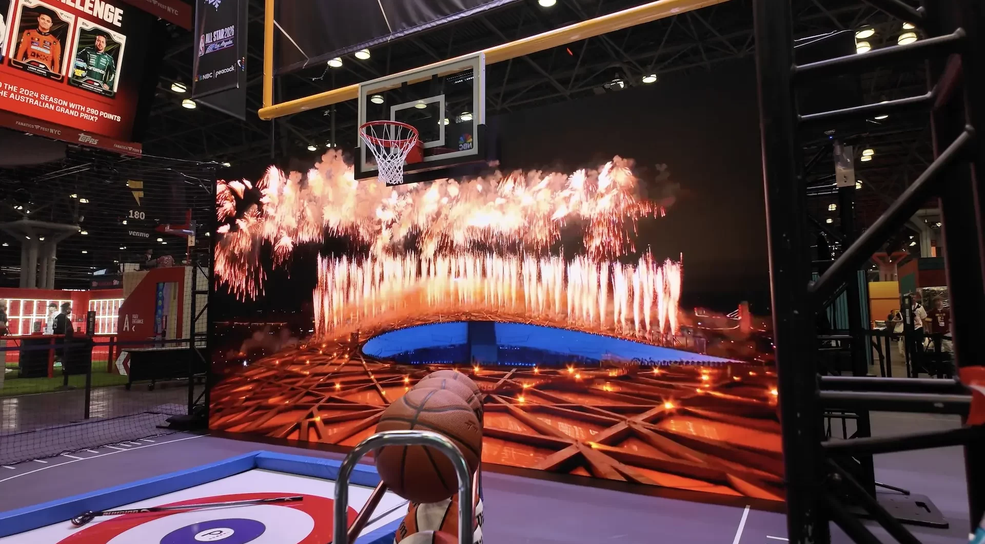 An interactive LED wall with firework visuals with a basketball hoop and goal post hanging over it