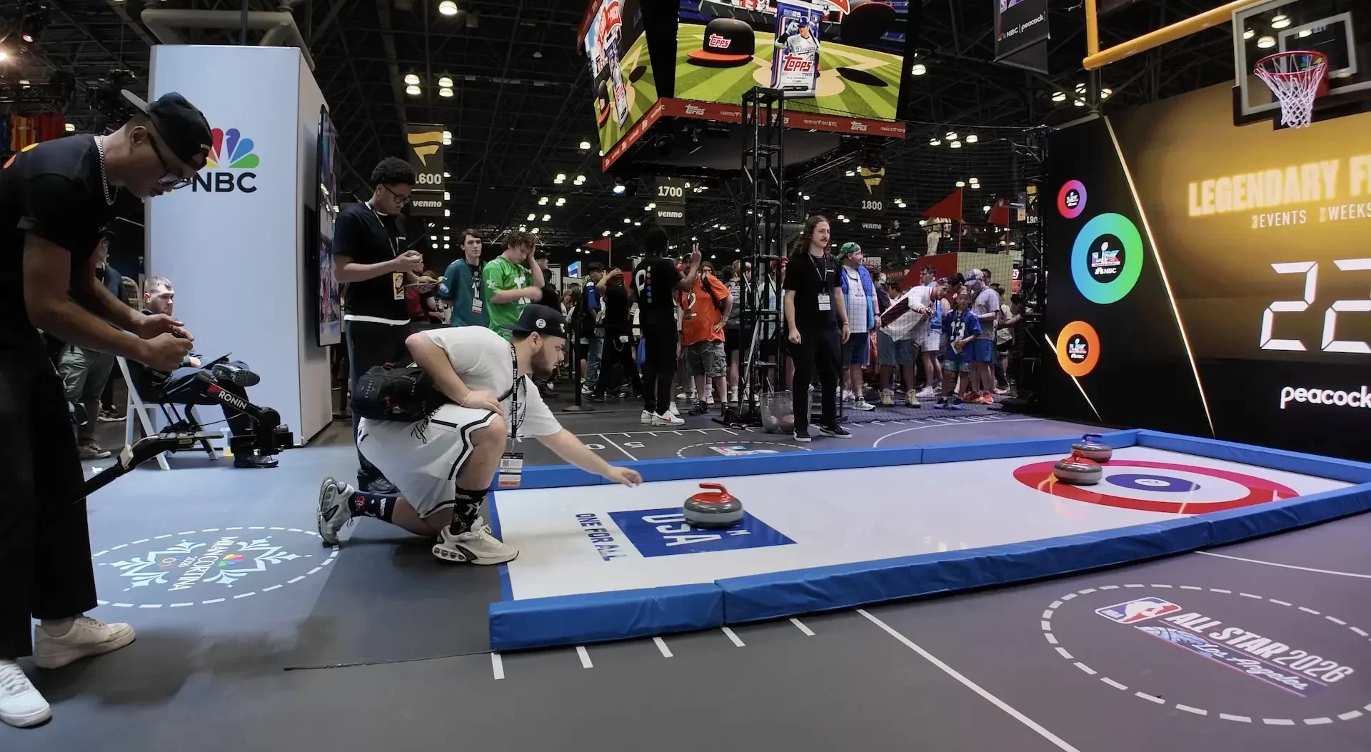 A videographer filming a competitor play "no-ice curling"