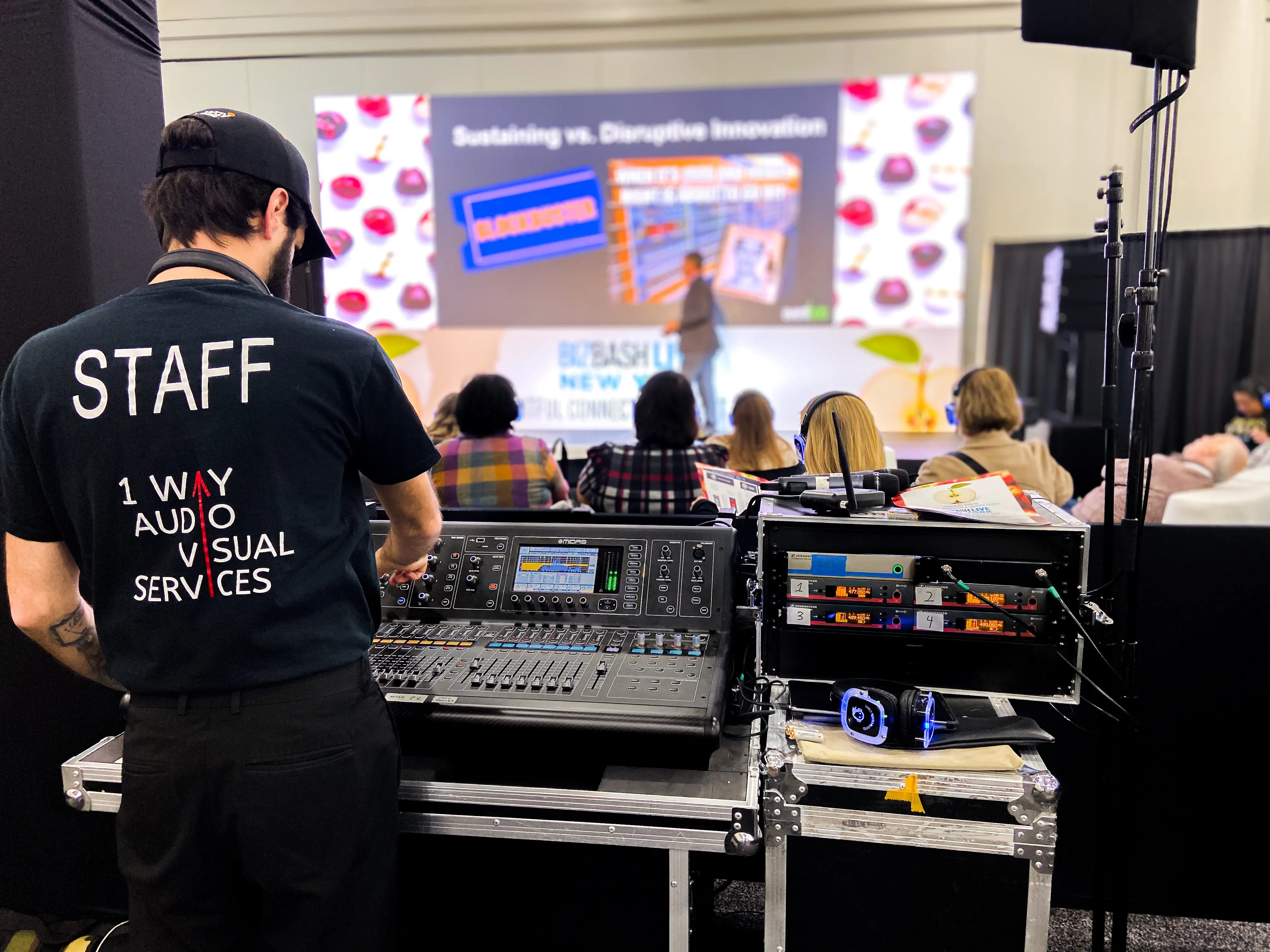 A OWEP technician working at a tech table during an event
