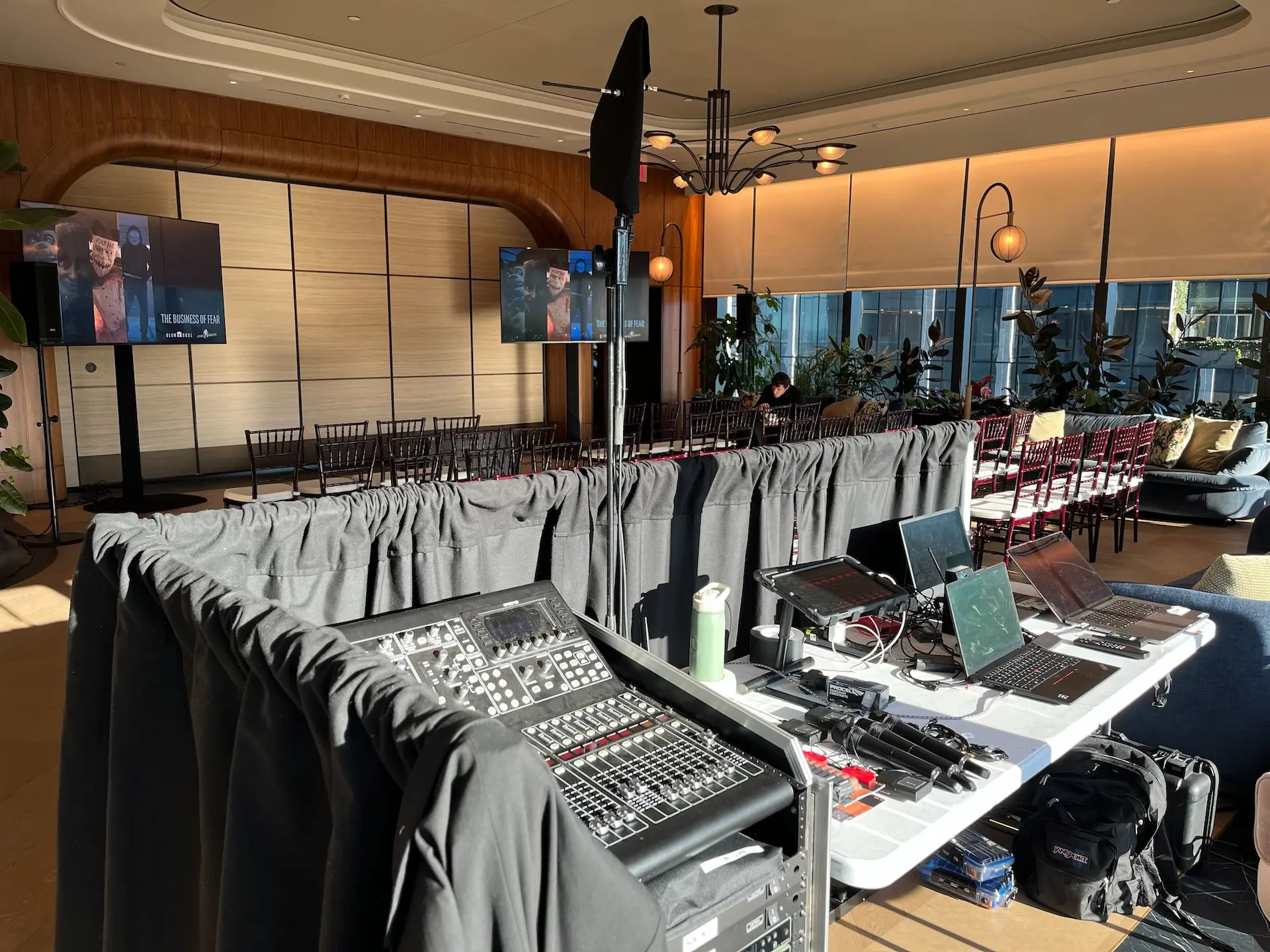 A tech table behind drapes at a live event