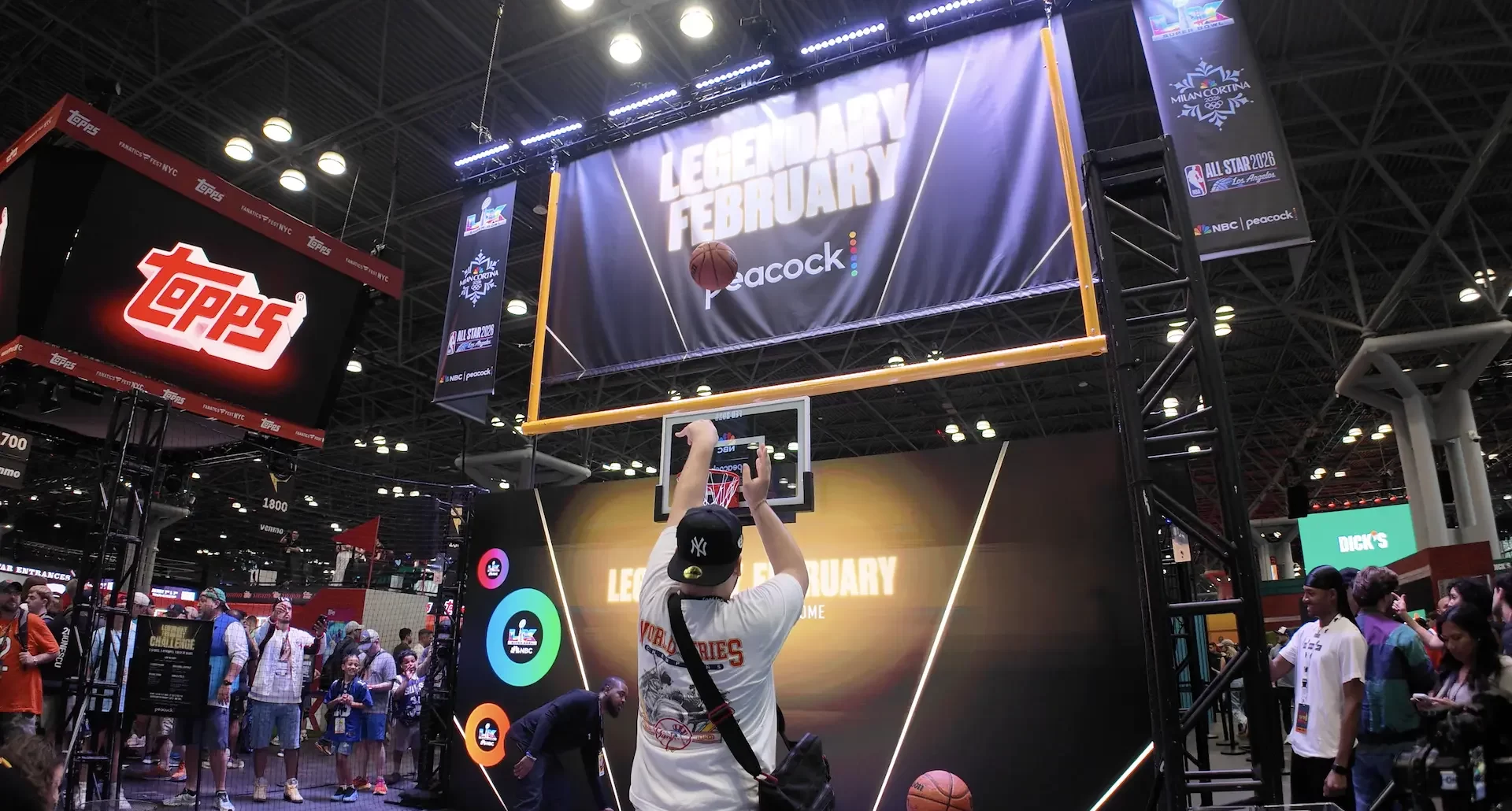 A man shooting a basketball at an interactive trade show booth