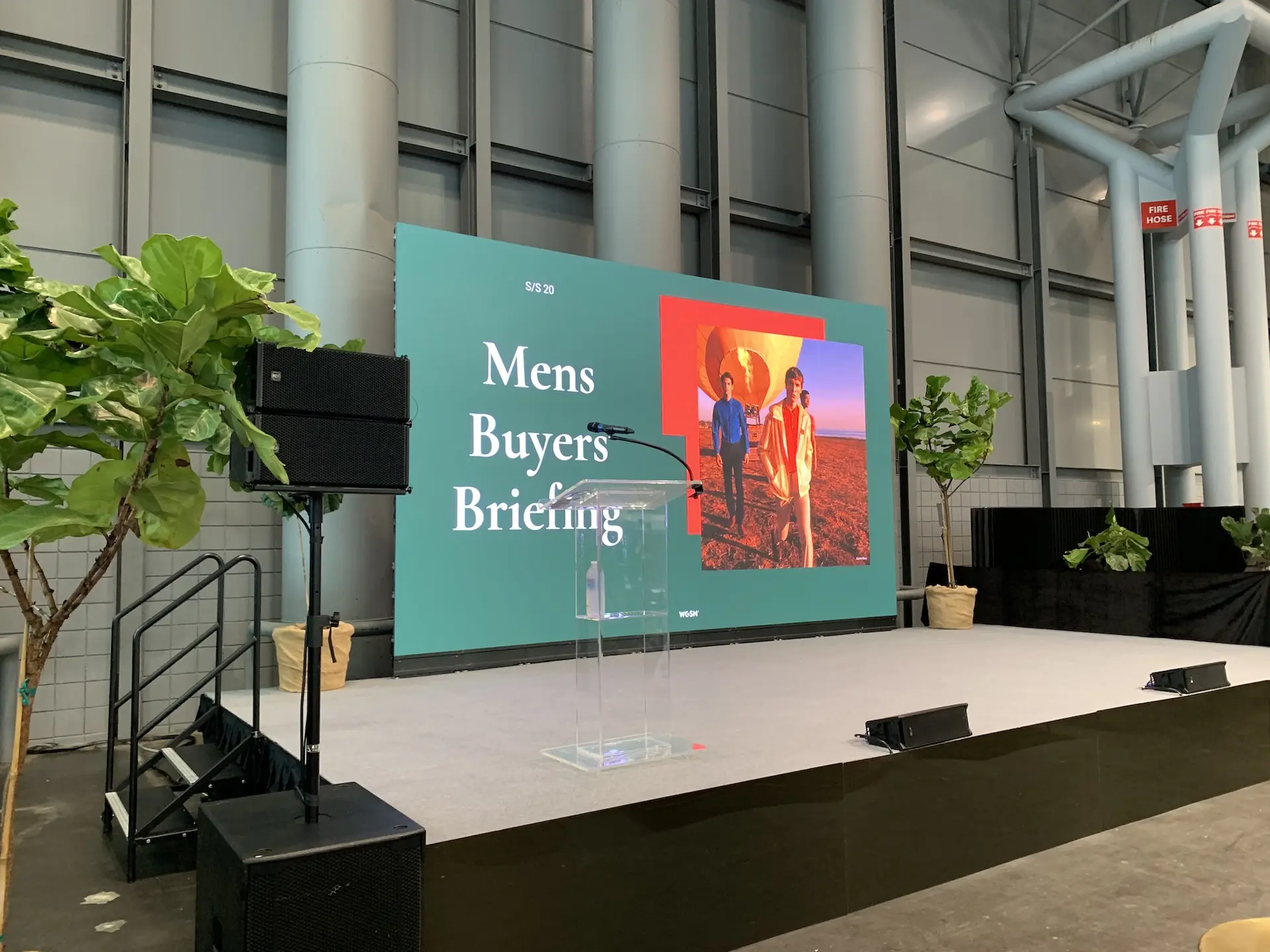 A stage with an LED wall and a clear glass podium