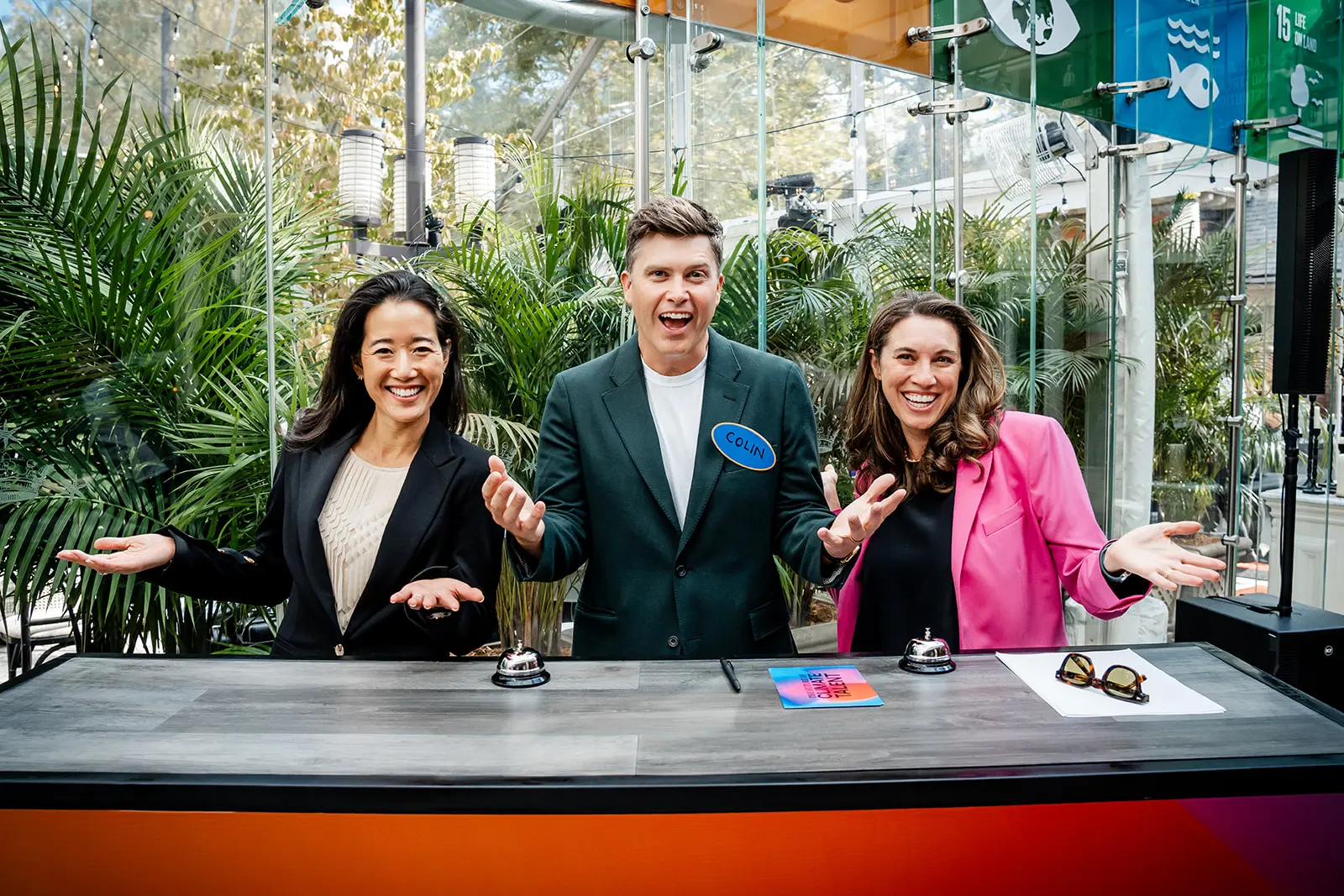 Colin Jost with two attendees at a live event