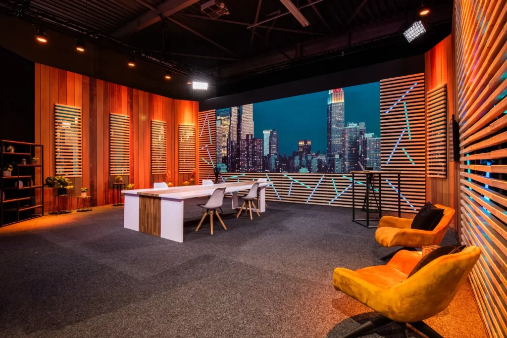 An image from the Aluvision website featuring a trade show booth build with hard scenic and an LED screen